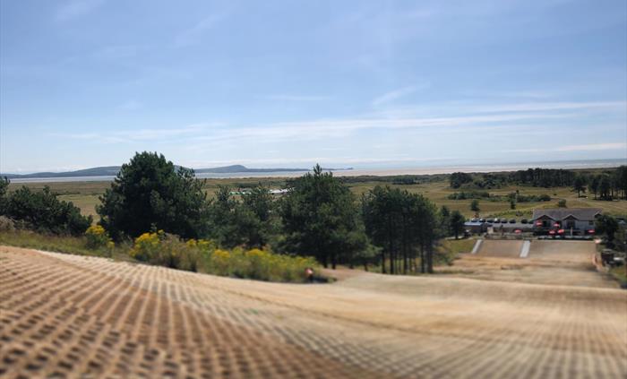 An artificial ski slope with a view to the seaside.